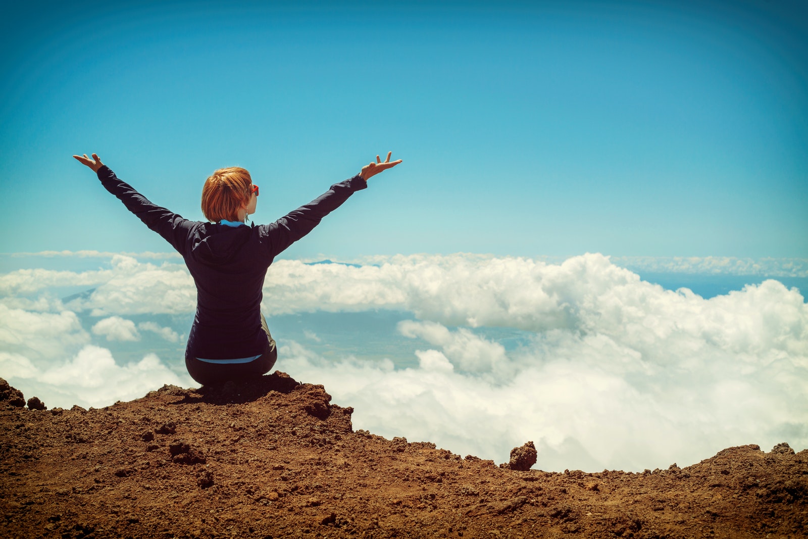 AIP Journey - Person at the top of a mountain, hands raised in celebration, embracing the AIP Journey of AIP Recipes and Lifestyle.