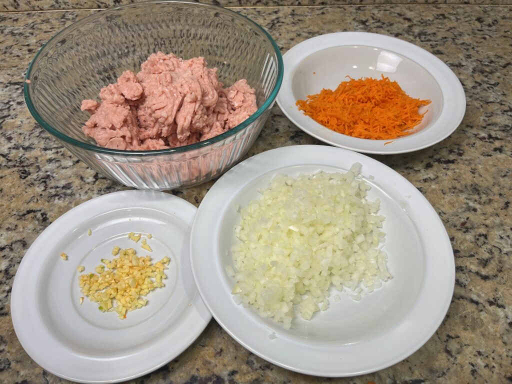 Ingredients for Romanian meatballs (Perisoare) including ground meat, herbs, and vegetables, ideal for AIP and gluten-free diets.