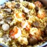 A nourishing AIP Chicken Paella, a grain-free Mediterranean dish with cauliflower rice, chicken, fresh vegetables, and anti-inflammatory herbs, served in a rustic bowl.