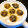 AIP Garlic Escargots served with fresh herbs and a drizzle of olive oil, showcasing a flavorful autoimmune-friendly dish