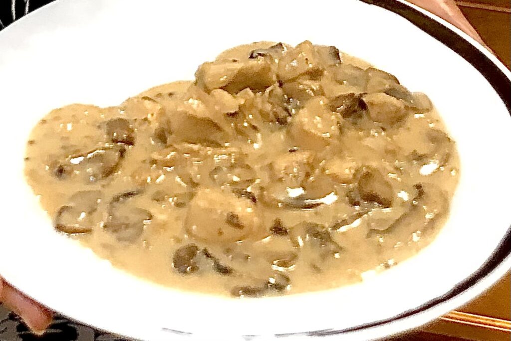 Creamy AIP Chicken Stroganoff with mushrooms, tender chicken, and a dairy-free sauce, served in a rustic dish, perfect for paleo and autoimmune diets.