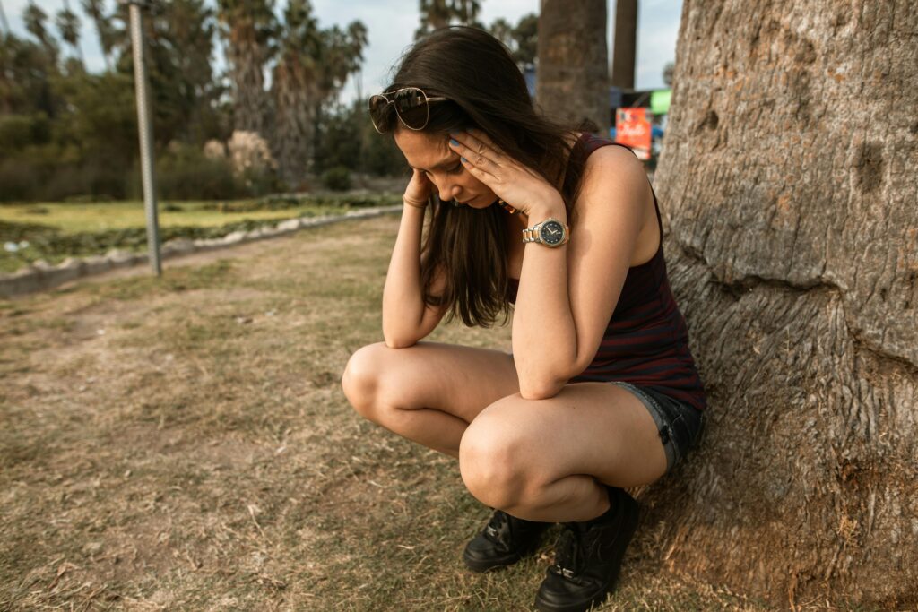 Chronic Stress and Autoimmune – person with hands on their head, symbolizing the mental and emotional strain caused by chronic stress in autoimmune disease management.