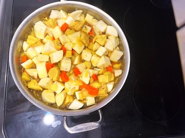 Chicken breast stew ingredients in the pot, sauteed.