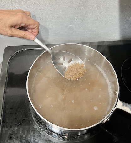 Cassava orzo boiling in a pot on the stove, a key step in preparing AIP-friendly Garlic Shrimp Cassava Orzo