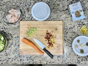 Diced carrots and celery sticks on a cutting board, prepped for AIP-friendly Garlic Shrimp Cassava Orzo.