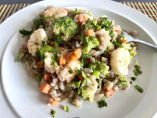 AIP-friendly Garlic Shrimp Cassava Orzo featuring juicy shrimp, vibrant carrots, celery, broccoli, and gluten-free cassava orzo, garnished with parsley