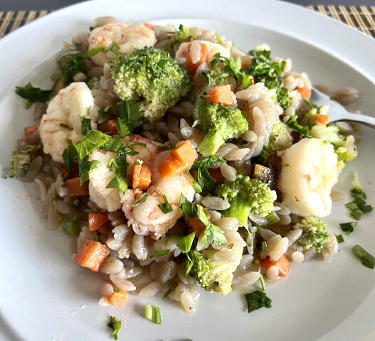 AIP-friendly Garlic Shrimp Cassava Orzo featuring juicy shrimp, vibrant carrots, celery, broccoli, and gluten-free cassava orzo, garnished with parsley