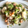 AIP-friendly Garlic Shrimp Cassava Orzo featuring juicy shrimp, vibrant carrots, celery, broccoli, and gluten-free cassava orzo, garnished with parsley