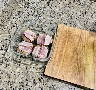 Pork chops wrapped in bacon, ready to be baked in the oven for an AIP Compliant and juicy meal.