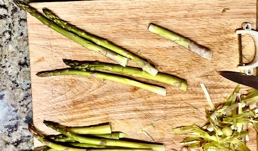 Step-by-step guide to cleaning fresh asparagus, showing how to rinse, soak, and trim the ends for perfect preparation.