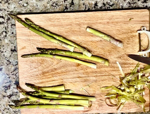 Step-by-step guide to cleaning fresh asparagus, showing how to rinse, soak, and trim the ends for perfect preparation.