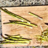 Step-by-step guide to cleaning fresh asparagus, showing how to rinse, soak, and trim the ends for perfect preparation.