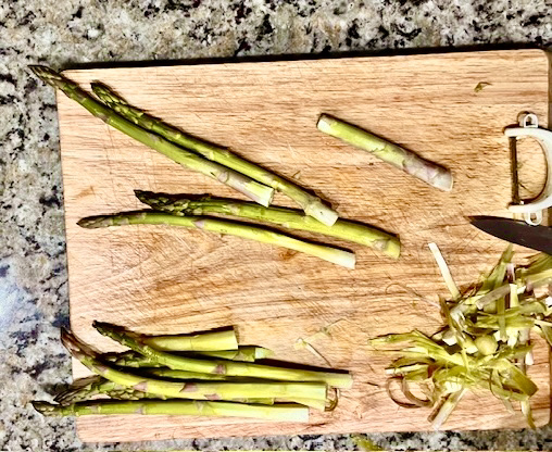 Step-by-step guide to cleaning fresh asparagus, showing how to rinse, soak, and trim the ends for perfect preparation.