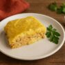 Turkey and Sweet Potatoes Moussaka made with mashed root vegetables and ground chicken, served on a white plate with fresh parsley and rustic props. Autoimmune-friendly, dairy-free, gluten-free, and nightshades-free.