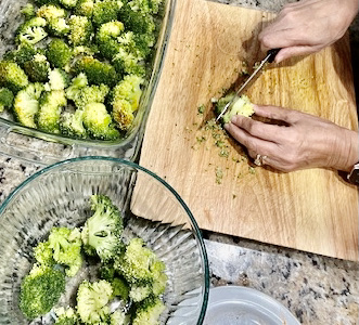 Slicing broccoli into thick 