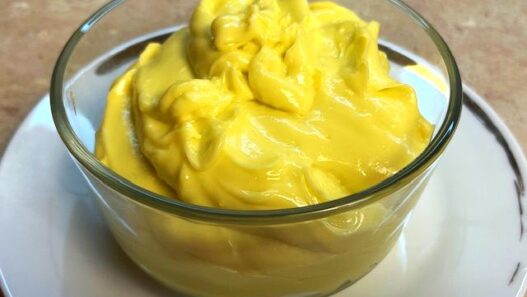 Close-up of a bowl with creamy homemade mayonnaise, suitable for AIP egg yolk reintroduction phase.