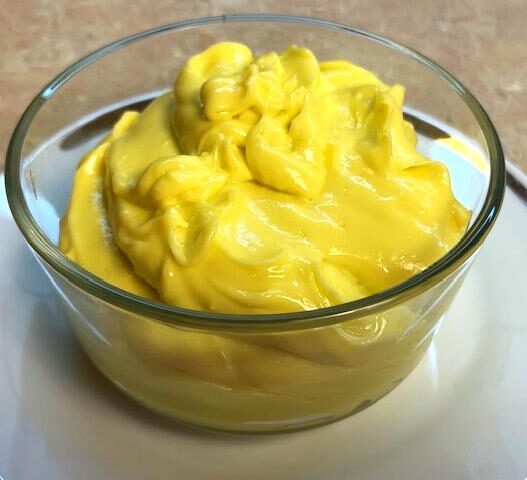 Close-up of a bowl with creamy homemade mayonnaise, suitable for AIP egg yolk reintroduction phase.