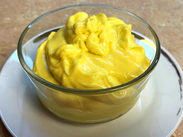 Close-up of a bowl with creamy homemade mayonnaise, suitable for AIP egg yolk reintroduction phase.