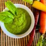 Garlic Kale Parmesan Pesto in a bowl, garnished with fresh basil leaves. Perfect for those in the AIP reintroduction phase, supporting gut health.