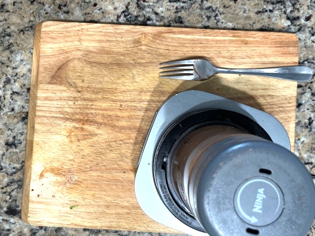 Food processor blending the ingredients for Cacao Avocado Pudding: avocado, cacao powder, coconut milk, maple syrup, and sea salt, gluten-free, dairy-free, and nut-free.