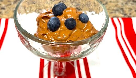 Creamy Cacao Avocado Pudding in a glass cup with fresh blueberries on top, gluten-free, dairy-free, nut-free, and nightshade-free.