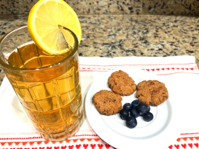 3 Carob and Green Banana Flour Cookies on a plate with a glass of tea and lemon wedge – AIP, gluten-free, paleo, healthy snack, immune-boosting.