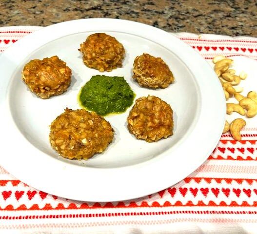 Cashew veggie meatballs served on a plate with kale pesto in the center, perfect for AIP, gluten-free, and plant-based diets.