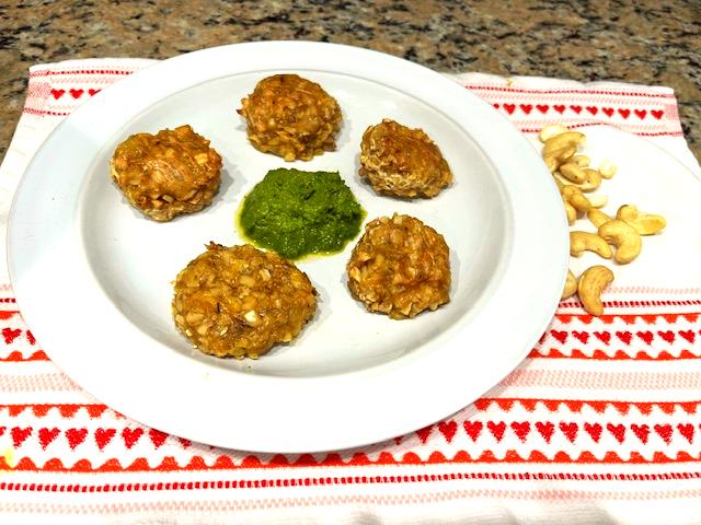 Cashew veggie meatballs served on a plate with kale pesto in the center, perfect for AIP, gluten-free, and plant-based diets.