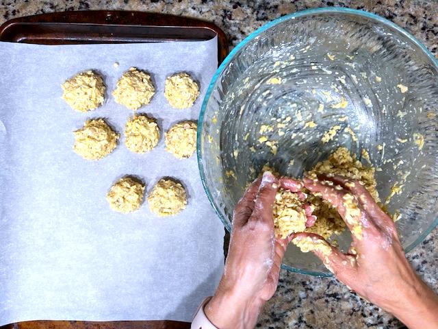 Mixing the ingredients for cashew veggie meatballs into a ball, showcasing the texture of the AIP-friendly mixture.