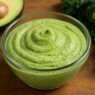 Creamy Kale Avocado dressing in a glass bowl with fresh kale and avocado, AIP compliant, dairy-free, gluten-free, healthy recipe