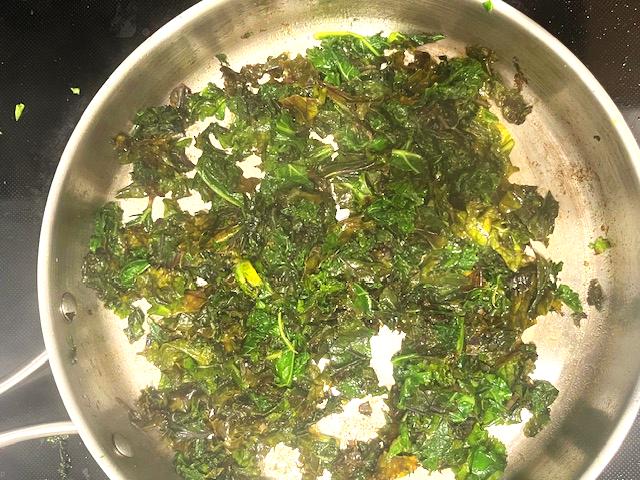 Freshly cooked Kale Sautéed with Cumin and Ghee in a skillet, ready to serve.