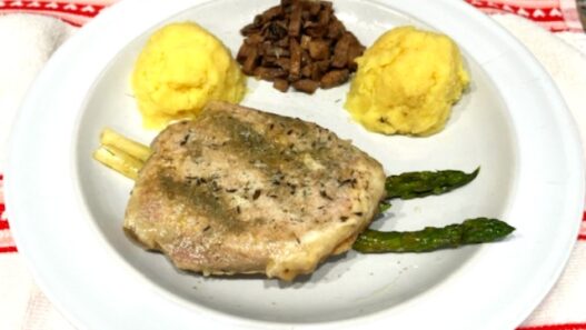 Ghee mashed sweet potatoes with pork chop on a plate, AIP-compliant meal