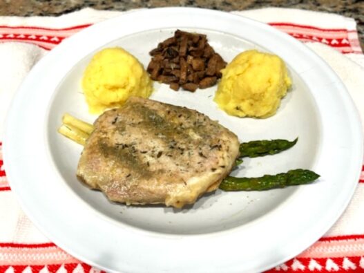 Ghee mashed sweet potatoes with pork chop on a plate, AIP-compliant meal