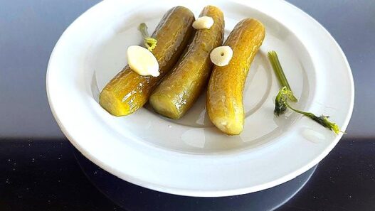 Homemade AIP Pickles with garlic, dill, and horseradish, fermented for a healthy, probiotic-rich snack