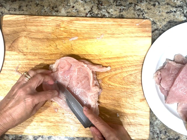 Butterflying a chicken breast step by step for the Tastiest Chicken Breast Schnitzel, a gluten-free, dairy-free, egg-free recipe.