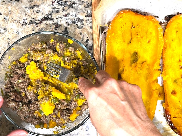 Stuffing roasted butternut squash with a mixture of roasted squash flesh and ground meat/veggie filling for Savory Stuffed Butternut Squash. AIP reintroduction, gluten-free, dairy-free recipe.