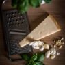 Grass-fed butter and Parmesan being shredded for a recipe