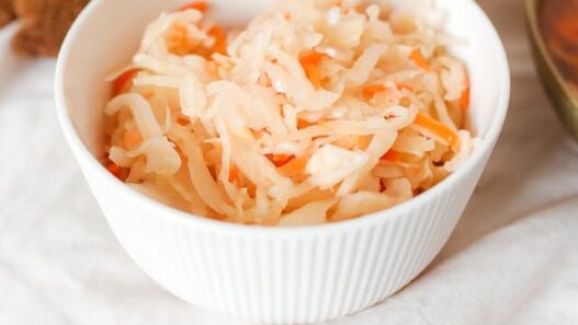 Homemade AIP Sauerkraut in a bowl, made with cabbage, carrots, and garlic, a probiotic-rich dish for gut health.