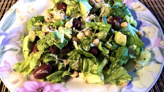 Sprouted Chickpea Salad on a plate with lettuce, avocado, grated carrot, and fresh herbs, perfect for grain-free, nightshade-free, gluten-free meals.