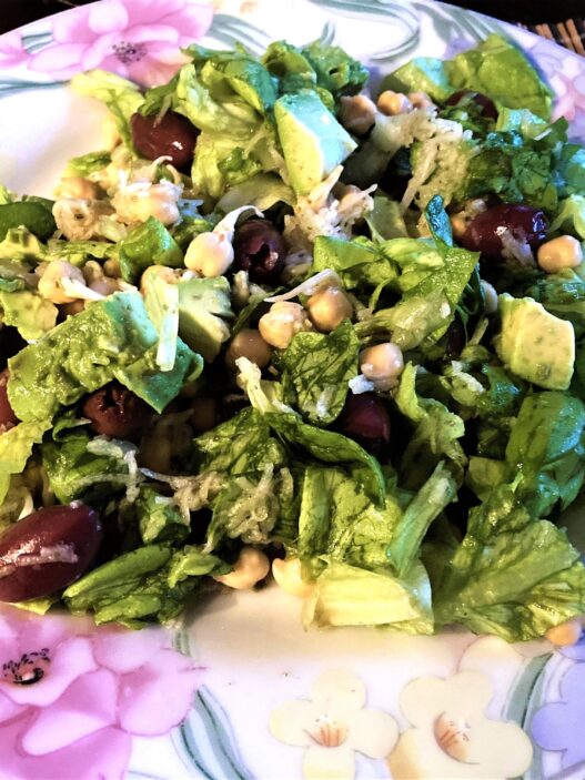 Sprouted Chickpea Salad on a plate with lettuce, avocado, grated carrot, and fresh herbs, perfect for grain-free, nightshade-free, gluten-free meals.