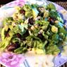 Sprouted Chickpea Salad on a plate with lettuce, avocado, grated carrot, and fresh herbs, perfect for grain-free, nightshade-free, gluten-free meals.