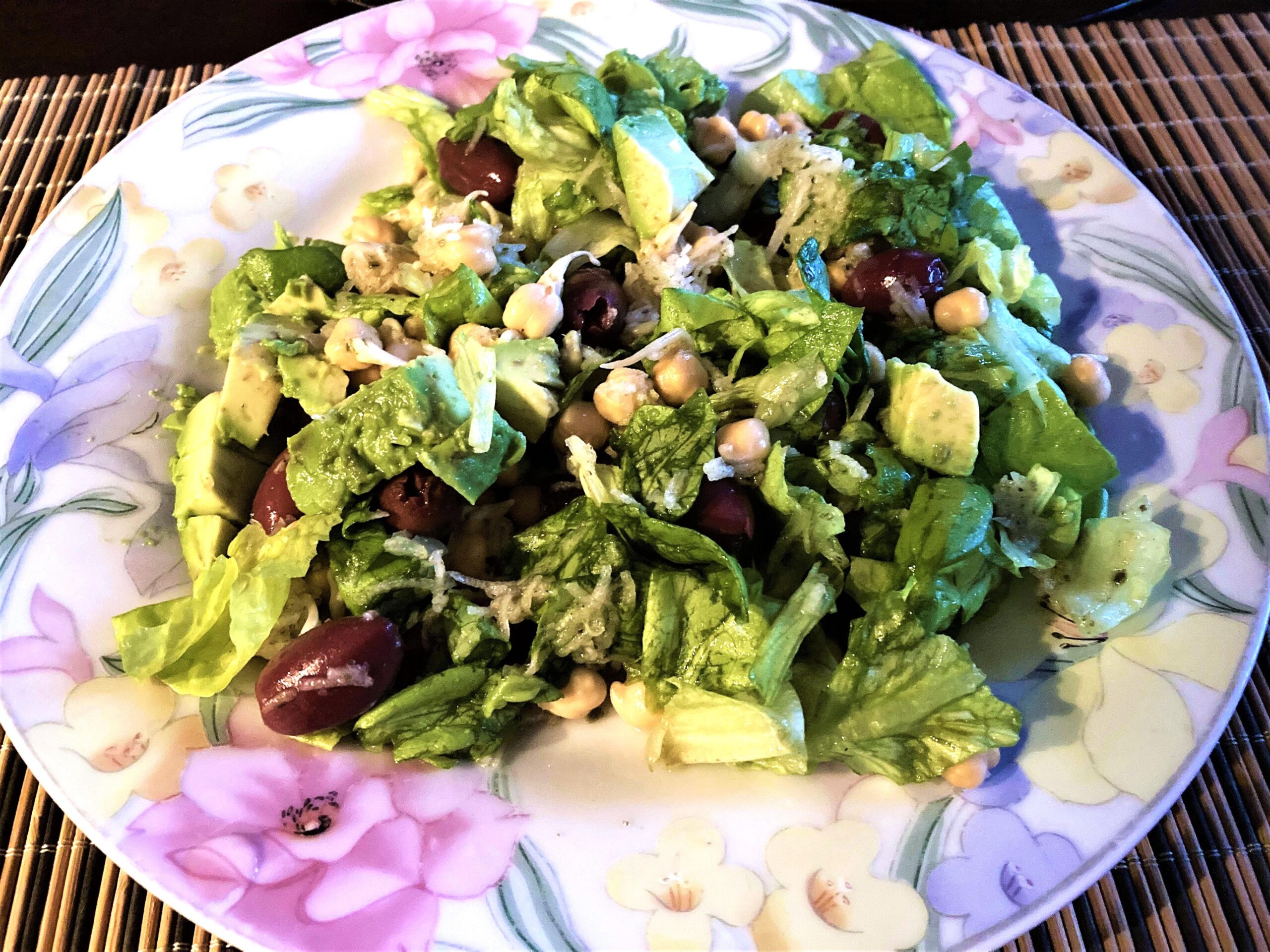 Sprouted Chickpea Salad on a plate with lettuce, avocado, grated carrot, and fresh herbs, perfect for grain-free, nightshade-free, gluten-free meals.