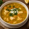 AIP Cioppino, a seafood stew made with shrimp, salmon, and mahi-mahi, in a rich tomato-free broth with carrots, onion, and herbs. Gluten and dairy free.