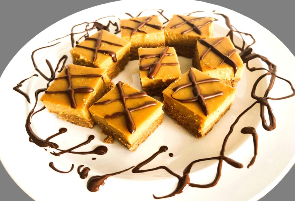 AIP Lemon Bars, No Coconut Flour topped with melted chocolate on a plate. Gluten-free, dairy-free, egg-free paleo dessert with tigernut crust and lemon filling.