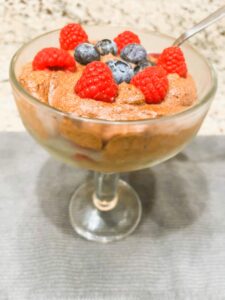 Aquafaba Chocolate Mousse in a cup topped with fresh blueberries and raspberries – vegan, dairy-free, AIP-friendly, anti-inflammatory dessert.