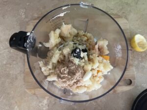 Blending cauliflower, butternut squash, lemon, and tigernut tahini for AIP Cauliflower Butternut Hummus, autoimmune-friendly dip without chickpeas