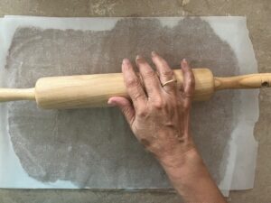 Rolling out dough for Crunchy Tasty AIP Crackers between parchment paper – cassava-free, gluten-free, paleo, autoimmune protocol elimination phase friendly.