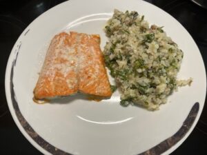 AIP Creamy Mushroom Risotto with salmon served on a white plate, cauliflower rice with shiitake and oyster mushrooms, autoimmune protocol recipe, grain free dairy free