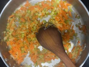 Onion, carrot, and celery sautéing for AIP Zucchini Boats, a gluten free, dairy free, nightshades free recipe that supports gut health.