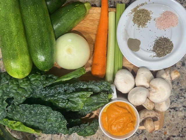 AIP Zucchini Boats ingredients, including zucchini, Dino kale, carrot, celery, onion, mushrooms, no-tomato sauce, and spices. Gluten free, dairy free, nightshades free.